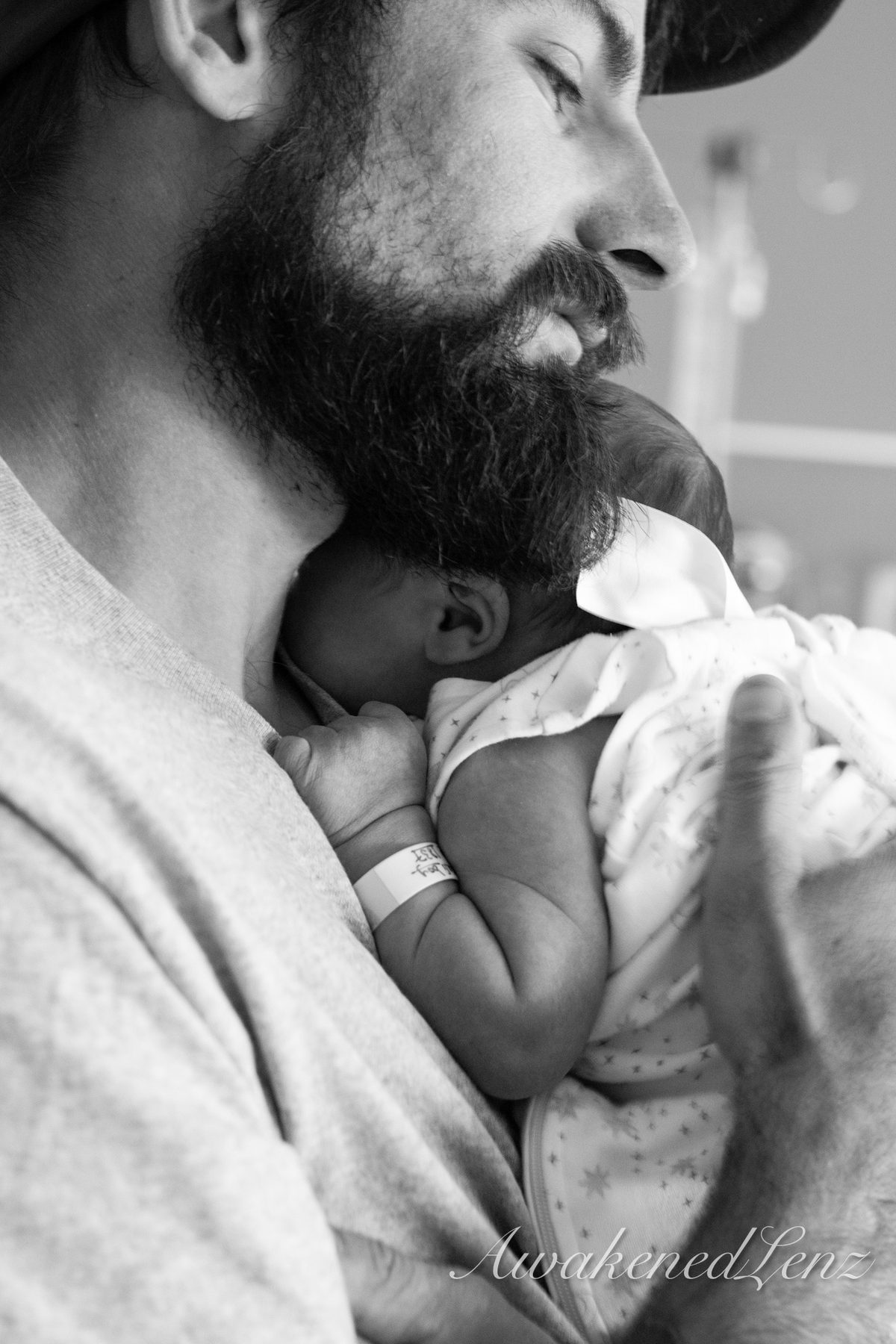 A father holding his newborn against his chest